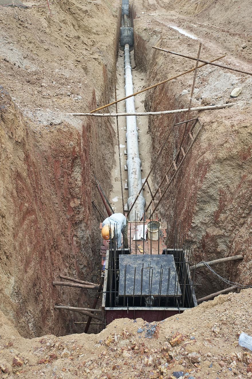 This image shows a commercial sewer line installment in a trench
