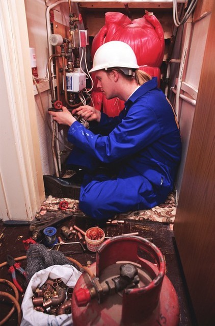 A professional plumber installing a gas piping system in a house