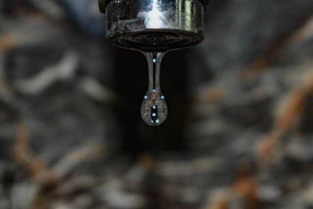 A closeup of a dripping faucet
