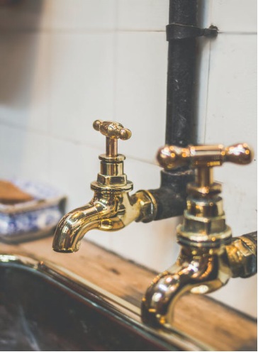 A close-up of gold faucets