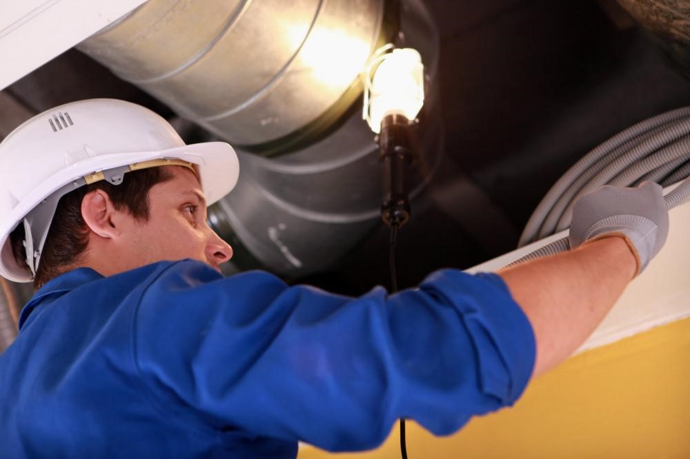 A plumber from Fort Worth inspecting drain pipes.