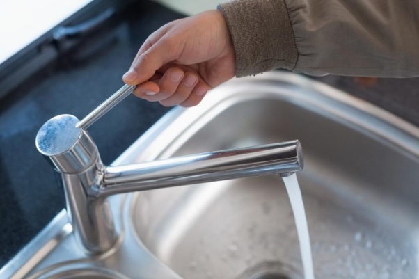 Checking the faucets in a home while the sewer line is being repaired