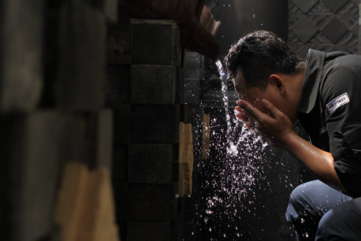  a man washing his face