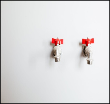 two faucets on a white wall